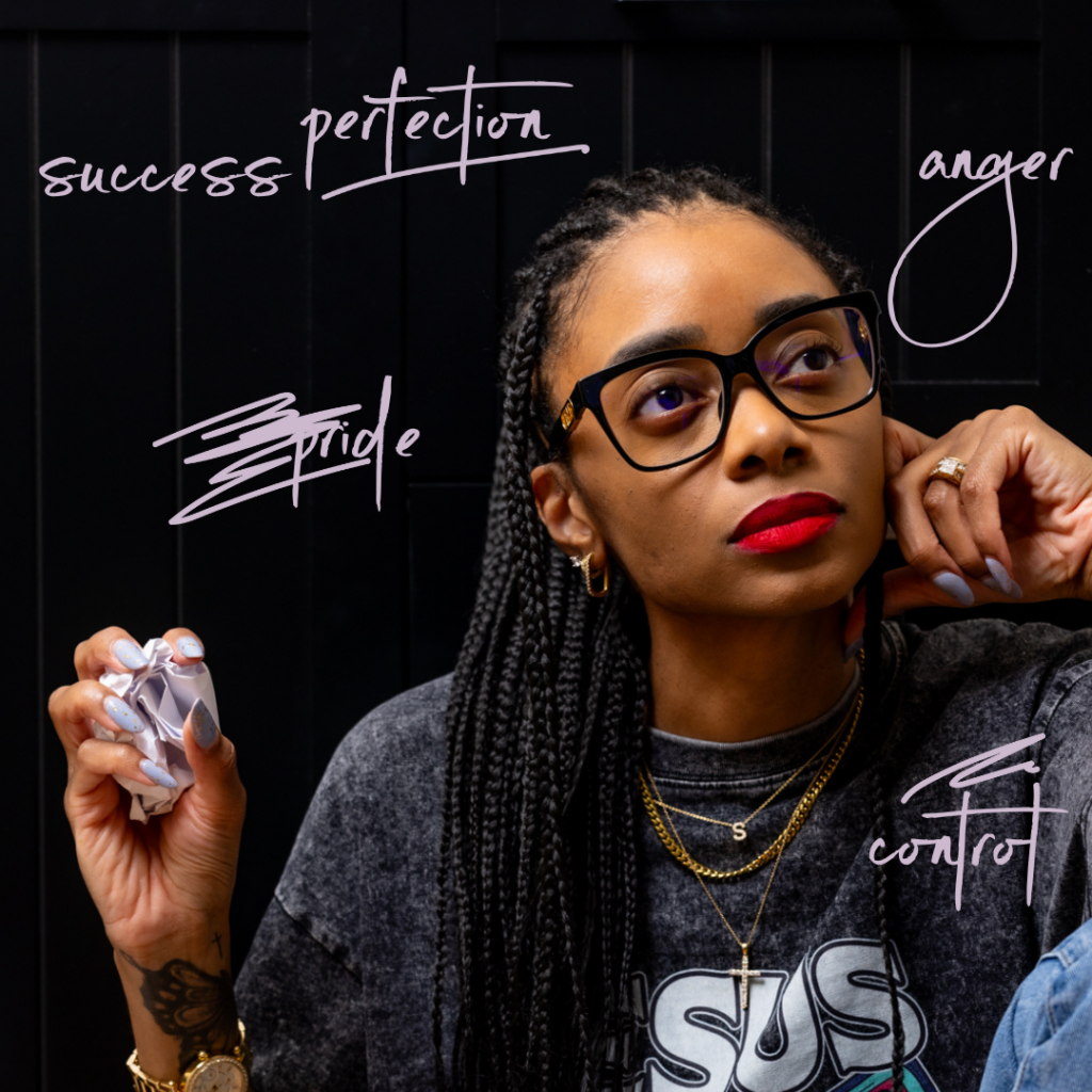 Image of Shanika holding a crumpled paper with words scratched out.