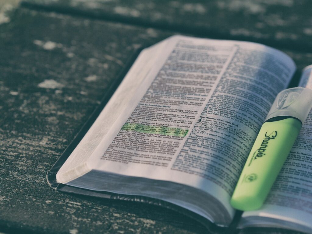 Image of the bible opened out with a highlighter.