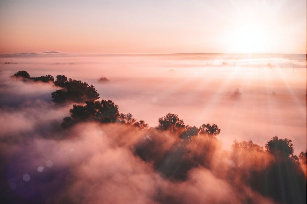 Image of the dawn of the sun above mountains.