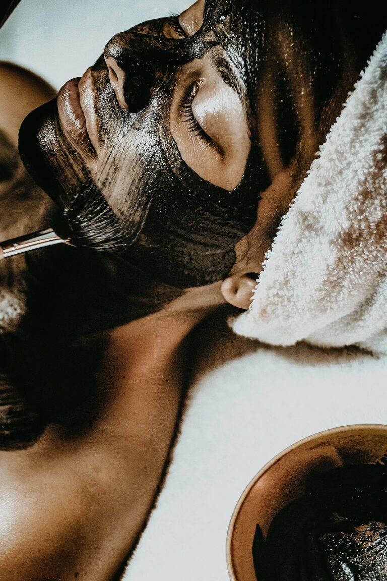 Image of a woman laying down with a facial mask.