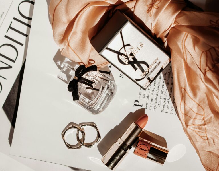 Image of perfume, lipstick, jewelry, and magazines.