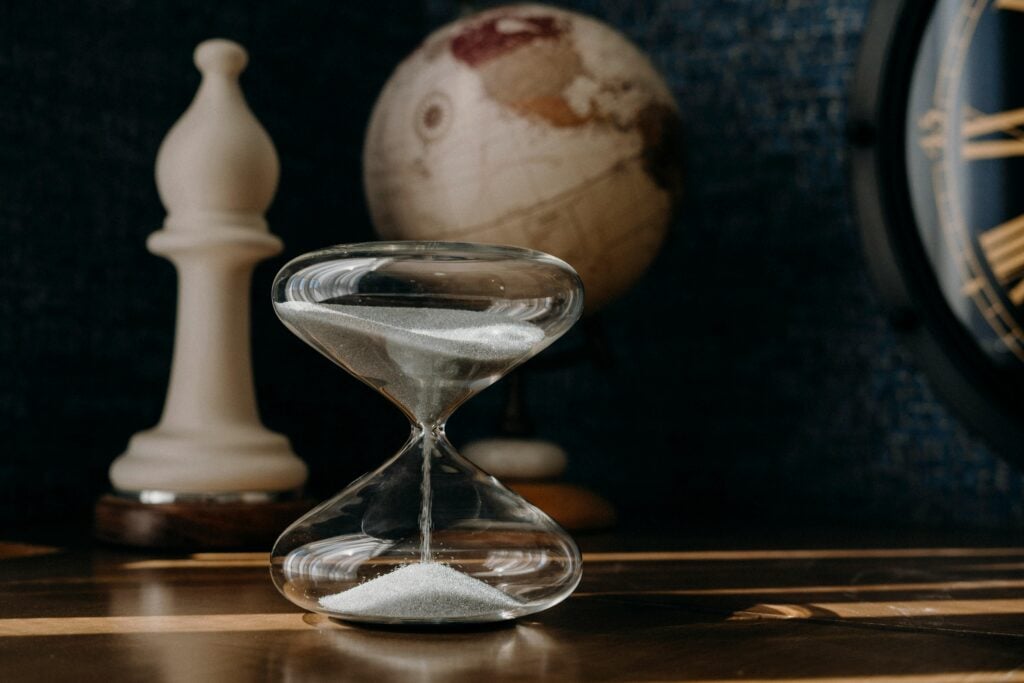 Image of hour glass on a table.