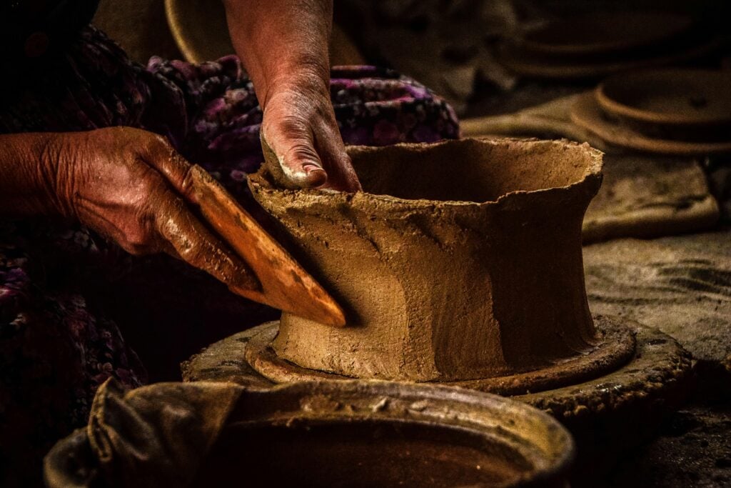 A potter's hands shaping clay.