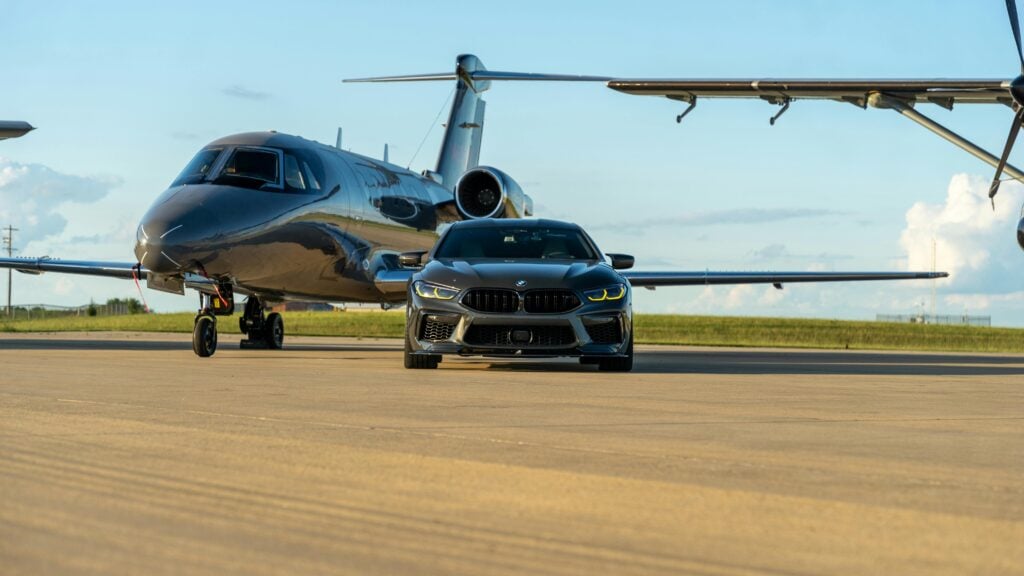 Image of luxury car and jet planes.