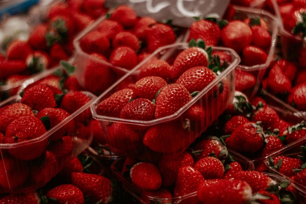 An abundance of strawberries in containers.