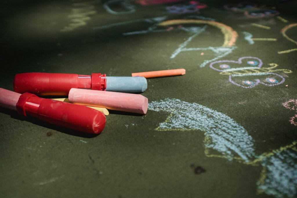 Colorful chalk being drawn on a pavement. 