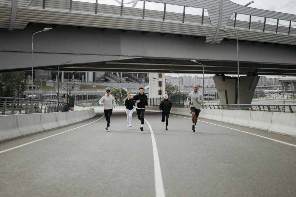 A group of people running on a highway.