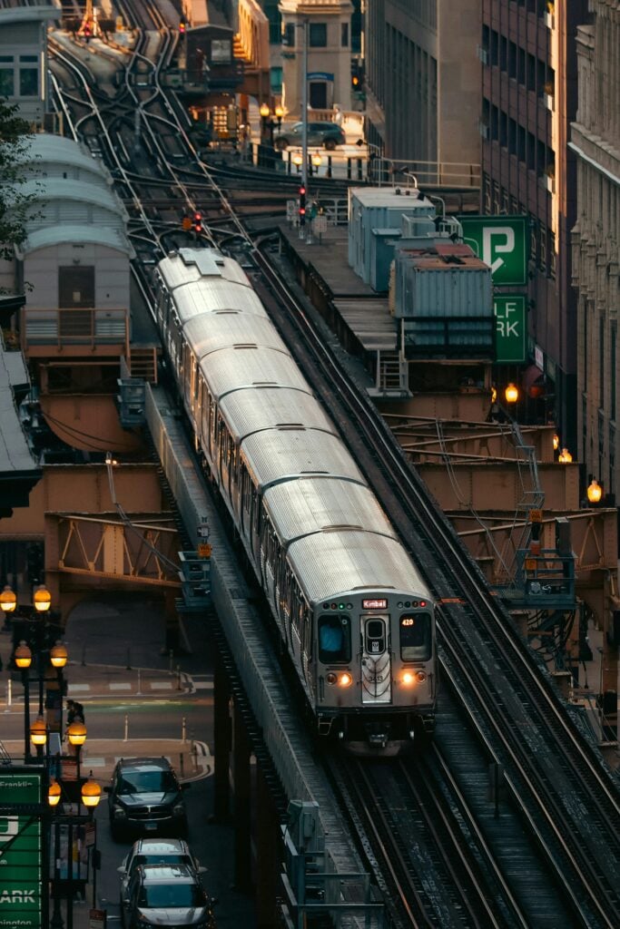 A subway train traveling on tracks throughout a city.