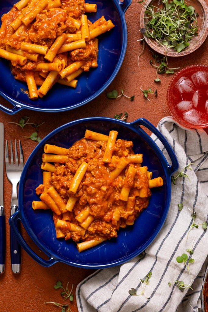 My Childhood Homemade Beefaroni in two bowls with utensils.