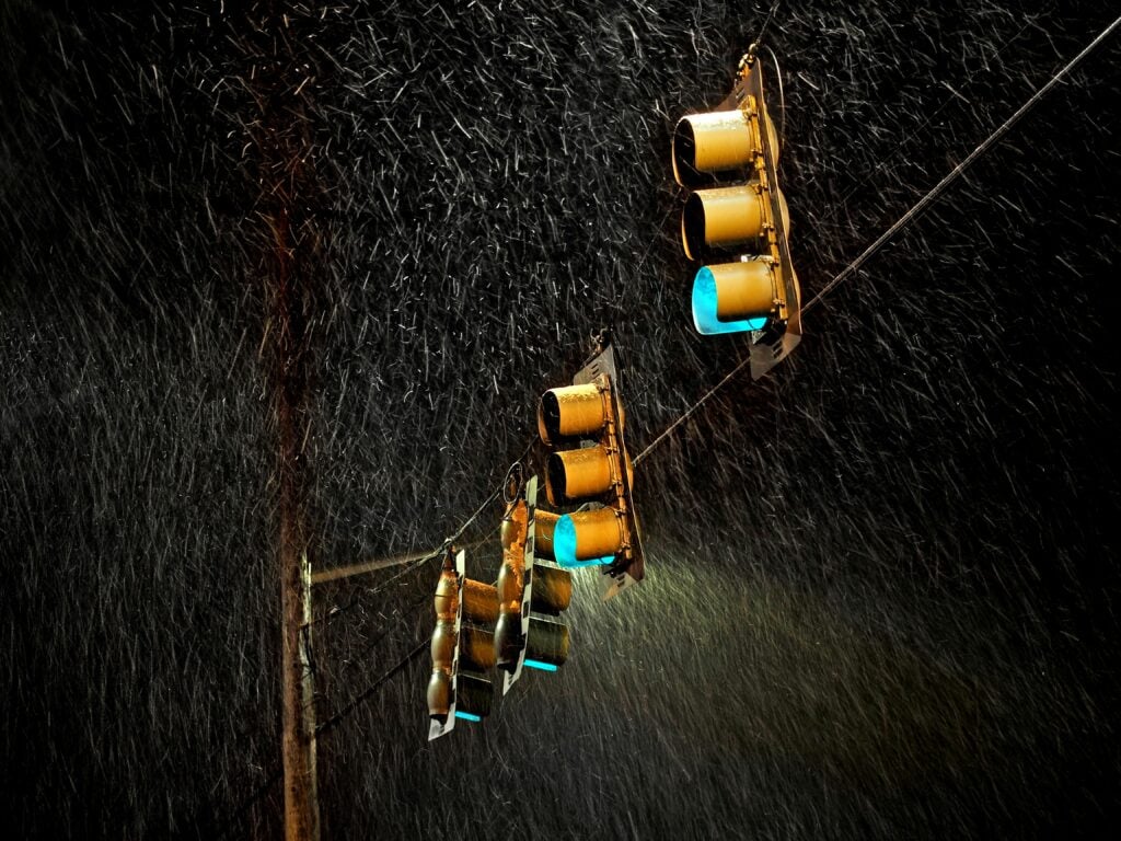Heavy rain on traffic lights and lines.