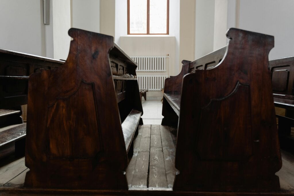 Empty church pew chairs.