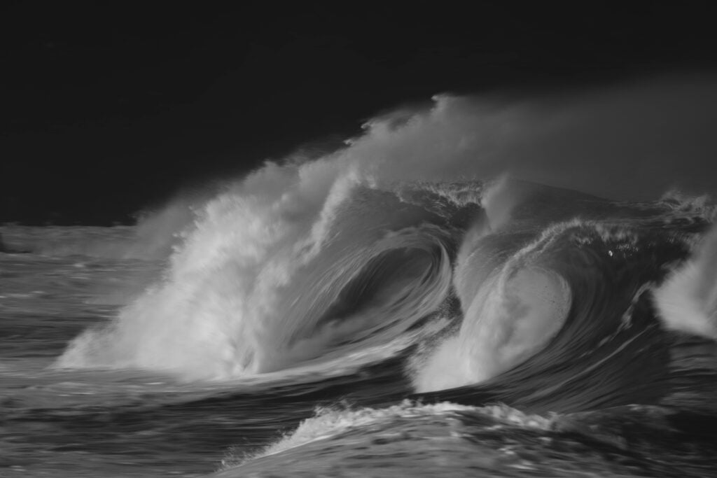 Stormy, raging water with dark sky.