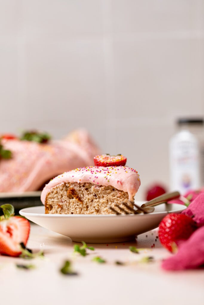 Sliced cake on a plate with a fork.