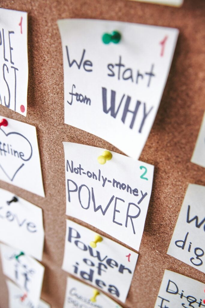Sticky notes pinned on a board with writing about personal vision.