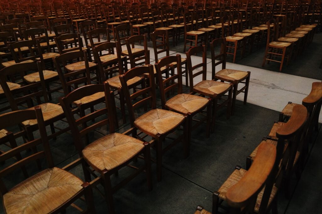 Rows of empty chairs in a building.