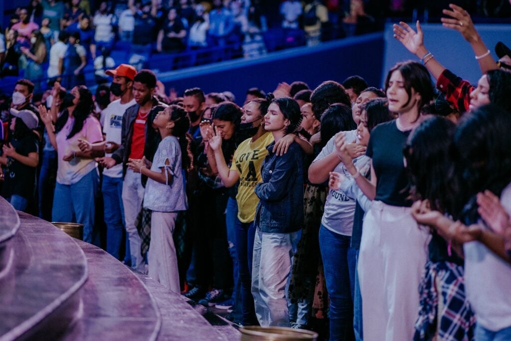 A group of people worshipping in a church.